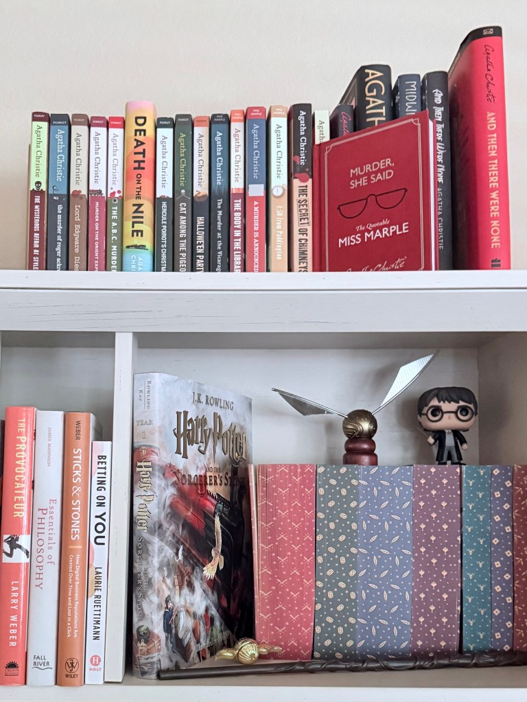 a shot of several Agatha Christie books and a few And Then There Were None special editions on the top shelf. The second shelf holds some design and philosophy books then Harry Potter special editions, the first illustrated Harry Potter book then a golden snitch and a HP Funko doll